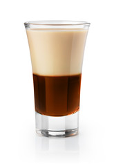 Shot glass of half cream half chocolate liqueur