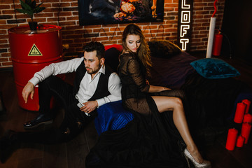 Sexy couple sitting on bed back to each other