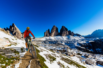 View of cyclist riding mountain bike on trail in Dolomites,Tre Cime di Laverado, South Tirol, Italy