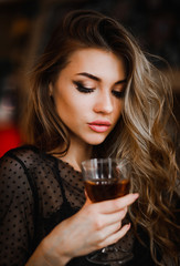 Portrait of a sexy woman holding a glass of wine in her hand