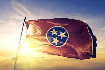Tennessee state of United States flag waving on the top sunrise mist fog