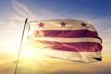 Washington DC of United States flag waving on the top sunrise mist fog
