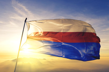 Manati municipality of Puerto Rico flag waving on the top sunrise mist fog