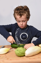 Fototapeta premium child peeling vegetables