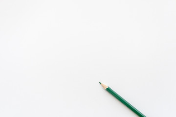 Green pencil on  white background. Top view