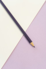 Vertical. Purple pencil on purple and white background. Art, scool or office shoot