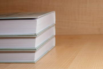 stack of books on wooden background