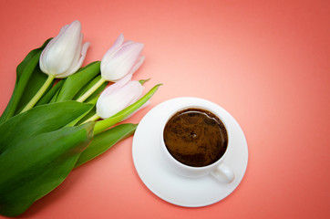 white tulips with white coffee Cup on pink background