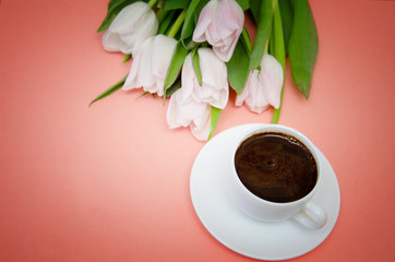 white tulips with white coffee Cup on pink background