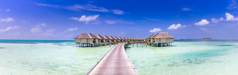 Landscape of Maldives beach. Tropical panorama, luxury water villa resort with wooden pier or jetty. Luxury travel destination background for summer holiday and vacation concept