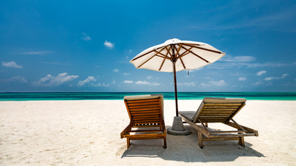 Beautiful Maldives island beach landscape. Luxury resort with chairs and umbrella for summer vacation and holiday background. Exotic tropical beach concept