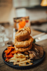 A close up shot of traditional British food, Sunday roast. Yorkshire pudding with roasted meat and vegetables. Concept of family lunch, celebration and traditional cuisine.