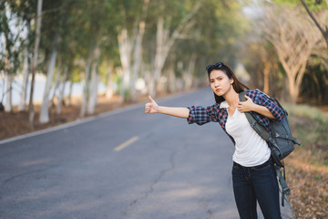 Portrait of a young attractive happy Asian woman traveler backpacker background with copy space