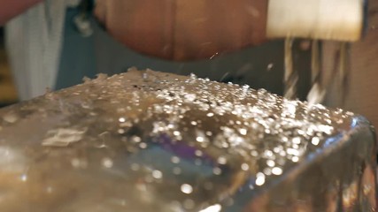 Barman is making brand ice for the cocktail at bar