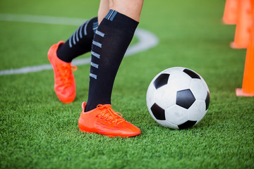 Fototapeta premium soccer player jogging with trap and control football between cone markers