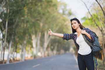 Portrait of a young attractive happy Asian woman traveler backpacker background with copy space