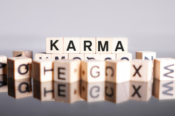 Karma word cube on reflection