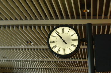 clock mobile on ceiling in modern business building