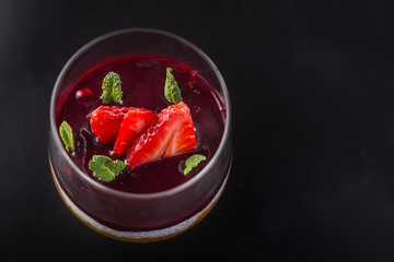 slices of ripe strawberries with mint leaves
