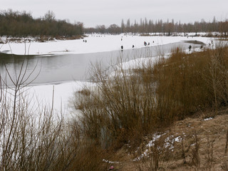 GOMEL, BELARUS - the beginning of spring. fishermen catch fish from the ice.