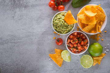 Delicious golden crispy chips with salsa and guacamole sauce