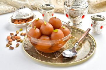 Gulab Jamun or Gulab Jaman in crystal bowl with arabian crockery