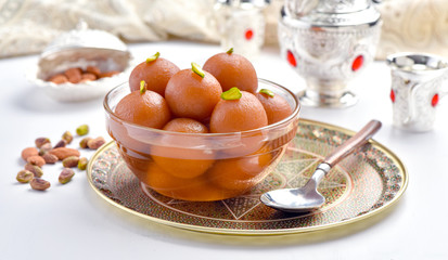 Gulab Jamun or Gulab Jaman in crystal bowl with arabian crockery