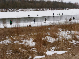 GOMEL, BELARUS - the beginning of spring. fishermen catch fish from the ice.