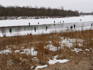 GOMEL, BELARUS - the beginning of spring. fishermen catch fish from the ice.