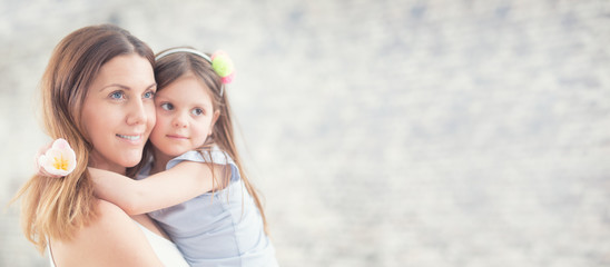 Happy mother's day concept. Portrait of loving mother with her daughter on her hands. Panoramic...