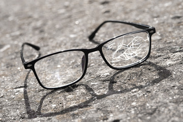 broken glasses lying on the street asphalt