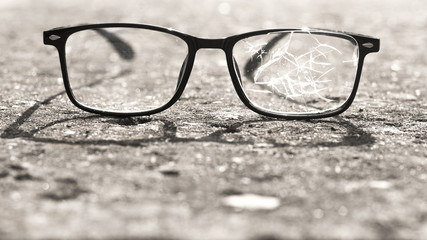 broken glasses lying on the street asphalt