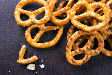 Salted pretzels on wooden background top view