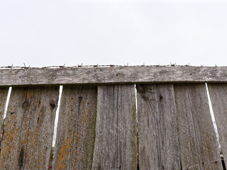 high fence with barbed wire on a white background.