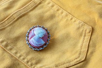 Women's cameo decoration on yellow background