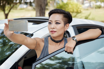 Stylish woman taking selfie