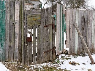 old wooden door of an old plank fence.