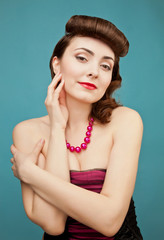 Beautiful woman with retro hairstyle on blue background