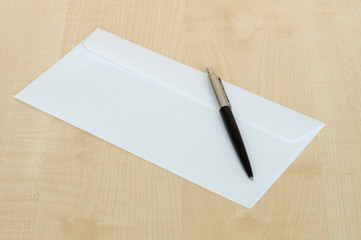 pen and a white envelope on the Desk