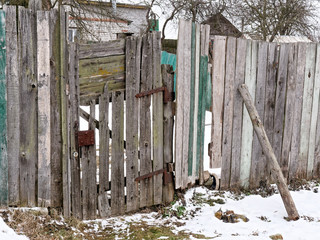 old wooden door of an old plank fence.
