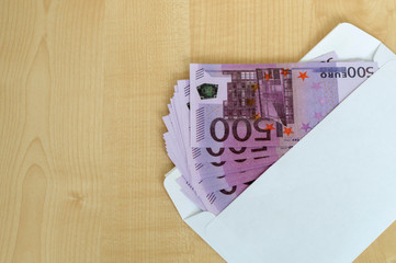 white envelope and cash on the table