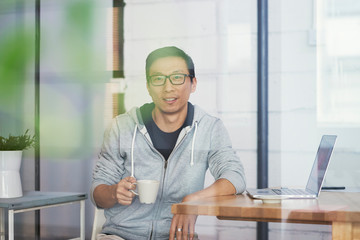 portrait of Asian businessman smiling and looking at camera