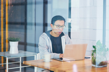 Portrait of Asian businessman working on laptop in office