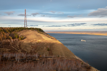 Power lines on the hill Tabaginsky Cape at sunset.  Yakutian landscape with the great Lena River at...