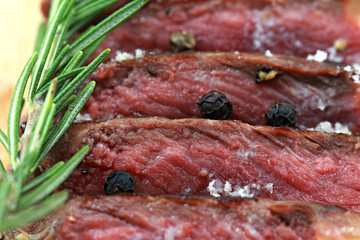 Medium Beef Rib Eye steak slices on wooden board