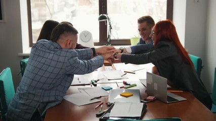 Business concept. A working team at the conference putting their hands together