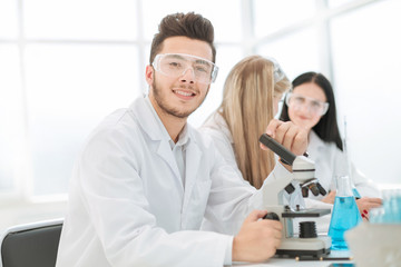 scientists biologists sitting at the laboratory table.