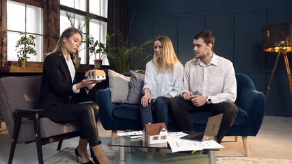Dolly shot of young couple on the meeting with architect.