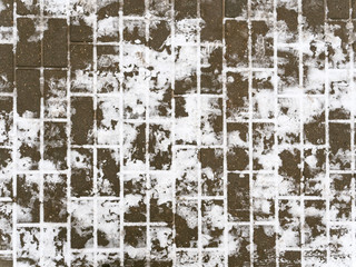 tile walkway covered with snow in winter.