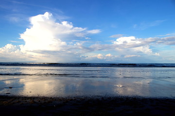 Scenery of the clouds in blue sky and sea with the beach in the evening time